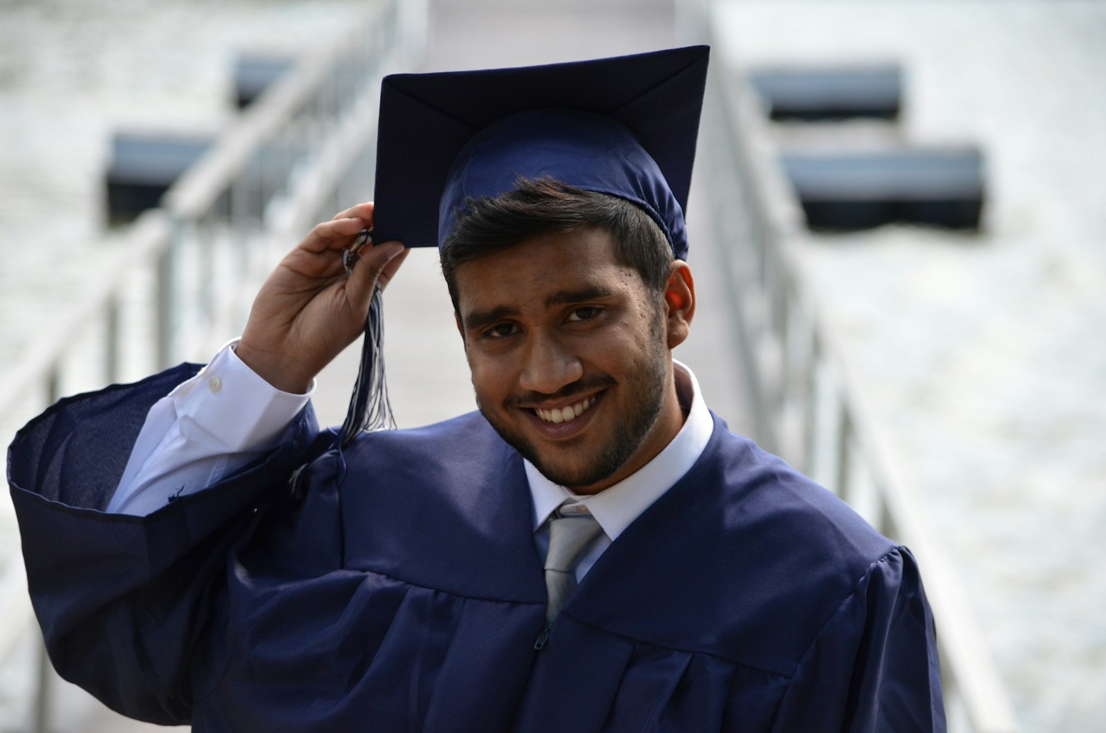 student holding his graduation cap